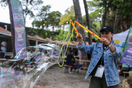 A person making soap bubbles at the Global Gathering 2023